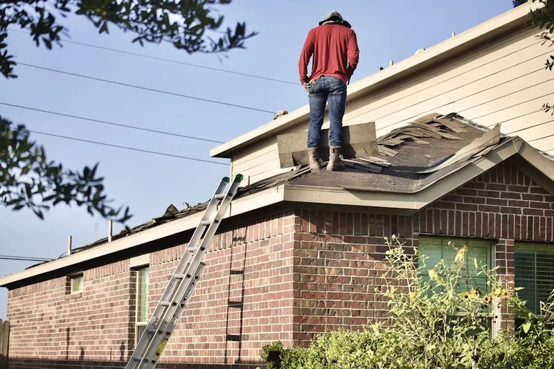 Professional roofer working on a residential roof in Oakwood